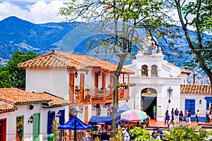 Medellin, Colombia - December 19, 2017: Facade view of clay rooftops with some colorful buildings and some people