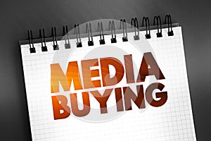 Media Buying - process used in paid marketing efforts, text concept on notepad