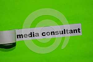 Media Consultant, business concept on green torn paper photo