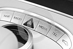 Media and navigation control buttons of a Modern car. Car interior details. White leather interior of the luxury modern car. Black