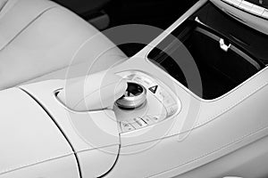 Media and navigation control buttons of a Modern car. Car interior details. White leather interior of the luxury modern car. Moder