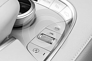 Media and navigation control buttons of a Modern car. Car interior details. White leather interior of the luxury modern car. Moder