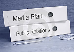 Media Plan and Public Relations - two binders in the office