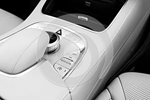Media volume and navigation control buttons of a Modern car. Car interior details. White leather interior of the luxury modern car