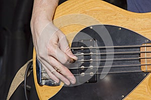 Mediator technique of playing with the right hand on a five string electric bass guitar