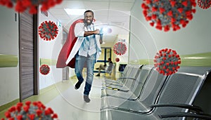 Medic acts like a superhero in hospital to fight pandemic of covid19 coronaviruses. Blue background photo