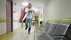 Medic acts like a superhero in hospital to fight pandemic of covid19 coronaviruses. Blue background