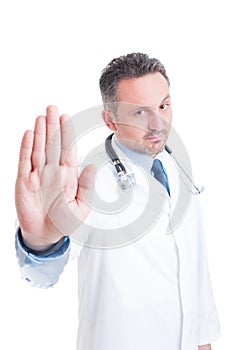 Medic or doctor showing palm as stop refuse or deny photo