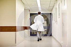 Medic or doctor walking along hospital corridor photo