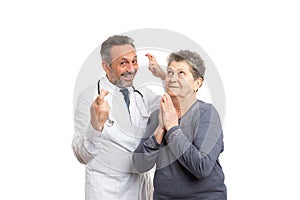 Medic holding fingers crossed and patient praying for good luck