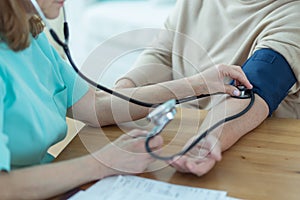 Medic measuring blood pressure