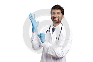 Medic putting on surgical glove