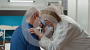 Medic using otoscope instrument to do ear examination