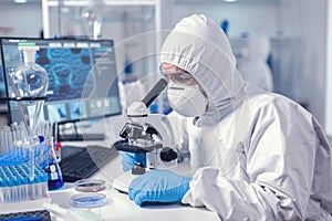 Medic working with microscope analyzing sample using microscope