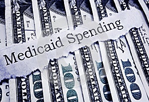 Medicaid Spending newspaper headline and cash