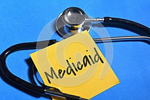 Medicaid wording with stethoscope on blue background. Medical concept