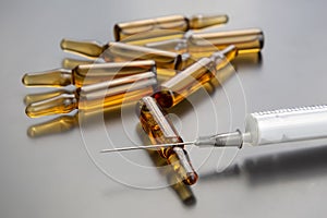 Medical ampoules for injection and a syringe. medicines and disease treatment. pharmacology and science