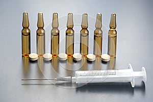Medical ampoules for injection, tablets and syringe. medicines and disease treatment. pharmacology and science