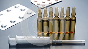 Medical ampoules for injection, tablets and syringe. medicines and disease treatment. pharmacology and science