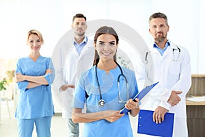 Medical assistant with colleagues in clinic photo