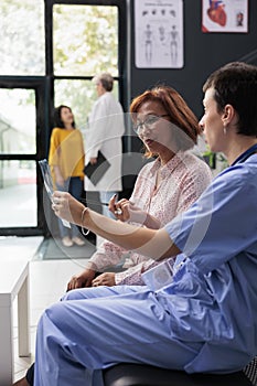 Medical assistant explaining bones x ray diagnosis