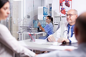 Medical assistant holding x-ray sitting in private hospital