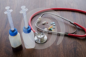 Medical background from pharmaceutical tablets and pills, stethoscope, heart and syringe.