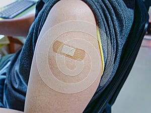 Medical Bandage Plaster on Man`s Arm After Getting Vaccinated