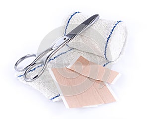 Medical bandage with scissors and sticking plaster