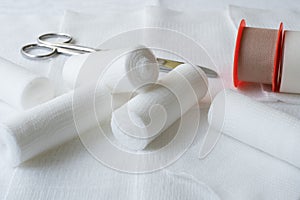 Medical bandages with scissors and sticking plaster. photo