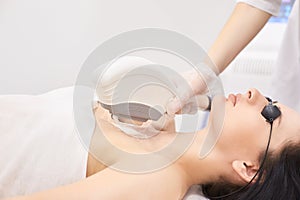 Medical beauty laser cosmeology procedure. Young female at salon. Professional doctor. Woman skincare technology. Hair removal