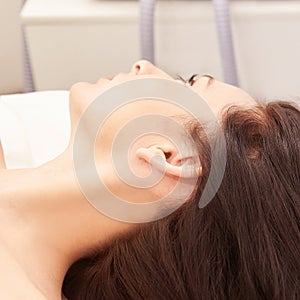 Medical beauty laser cosmeology procedure. Young female at salon. Professional doctor. Woman skincare technology. Hair removal