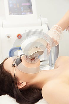 Medical beauty laser cosmeology procedure. Young female at salon. Professional doctor. Woman skincare technology. Hair removal