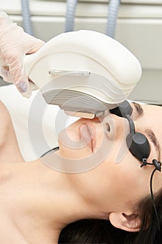 Medical beauty laser cosmeology procedure. Young female at salon. Professional doctor. Woman skincare technology. Hair removal