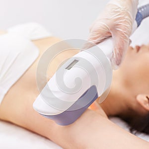 Medical beauty laser cosmeology procedure. Young female at salon. Professional doctor. Woman skincare technology. Hair removal