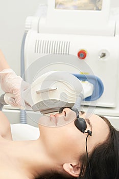 Medical beauty laser cosmeology procedure. Young female at salon. Professional doctor. Woman technology. Hair removal
