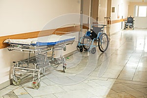 Medical bed, wheelchair, in the corridor of the hospital inpatient department