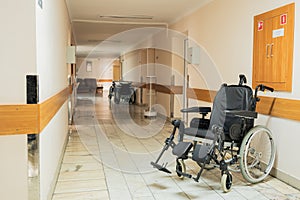 Medical bed, wheelchair, in the corridor of the hospital inpatient department