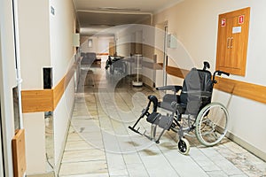 Medical bed, wheelchair, in the corridor of the hospital inpatient department