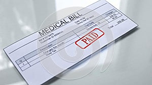 Medical bill paid, seal stamped on document, payment for services, tariff