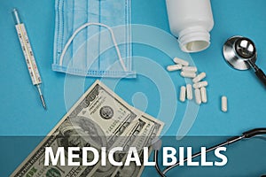 Medical bills, medicine concept. Scattered pills and stethoscope , masks money, thermometer on a blue background