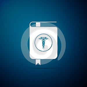 Medical book and Caduceus medical symbol icon isolated on blue background. Medical reference book, textbook