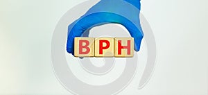 Medical and BPH Benign Prostatic Hypertrophy Hyperplasia Blood Pressure High symbol. Doctor holds wooden blocks with the word `BP