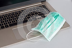 Medical breathing mask on laptop for  home office