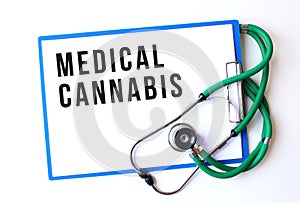 MEDICAL CANNABIS text on a medical folder and stethoscope on white background