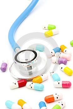 Medical capsules and pills with happy smiling faces on white background