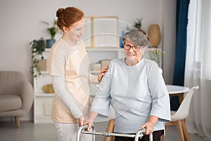 Medical caretaker helping senior woman photo