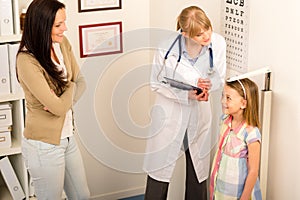 Medical check-up at pediatrist girl measure height photo