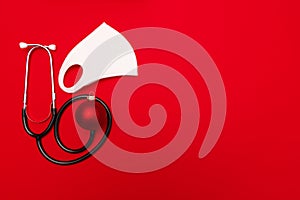 Medical Christmas banner with stethoscope on red background.