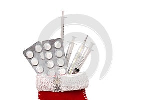 Medical Christmas card with pills, thermometer, syringes, on a white wooden background. Copyspace. Medicine new year flatly